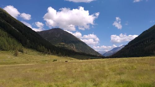 Scenic view of landscape and mountains against sky