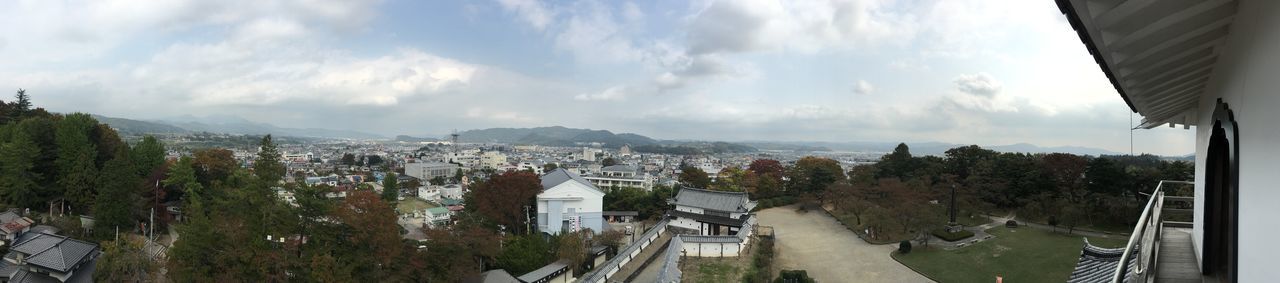 architecture, built structure, building exterior, sky, cloud - sky, city, tree, cloud, high angle view, cloudy, panoramic, water, cityscape, residential district, residential structure, residential building, day, road, mountain, outdoors