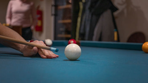 Person playing with ball on table
