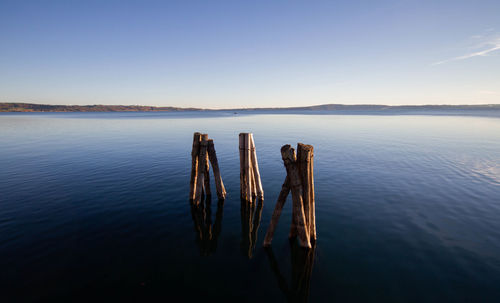 Landscape of lake bracciano in twilight with timber pier