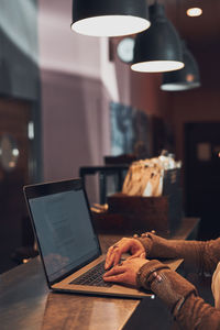 Man using laptop on table at home