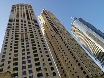 Low angle view of modern buildings against clear sky