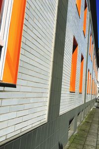 Low angle view of orange wall by building