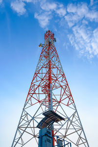 Low angle view of communications tower against blue sky