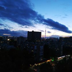 High angle view of illuminated buildings against sky at night