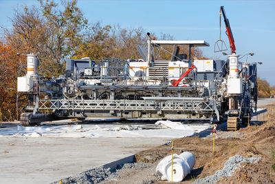 Industrial concrete paver is laying a new transport road with high performance.