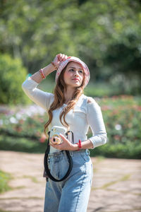 Young woman standing against white outdoors