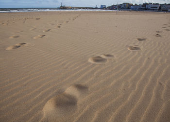 High angle view of footprints on sand at beach