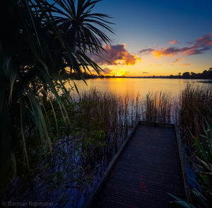 Scenic view of lake against sky during sunset