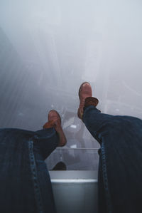 Low section of man standing in water