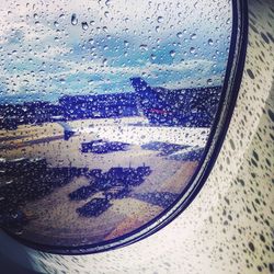 Reflection of sky seen through wet glass window