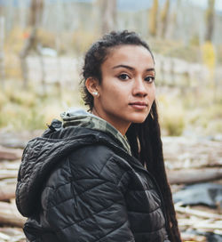 Portrait of young woman standing outdoors