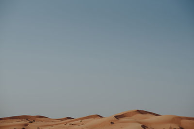 Low angle view of desert against clear sky