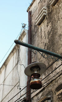 Low angle view of street light against building