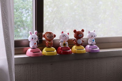 Close-up of toys on table by window