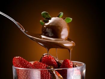 Close-up of fruits in bowl against black background