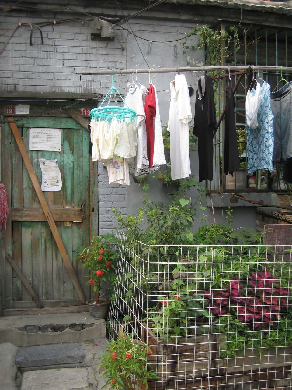 CLOTHES DRYING ON CLOTHESLINE AGAINST WALL