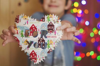 Midsection of woman holding christmas decoration