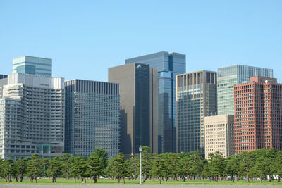 Modern buildings against clear blue sky