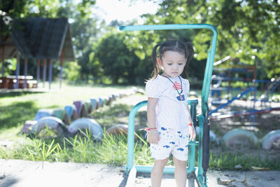 Portrait of cute girl sitting on grass