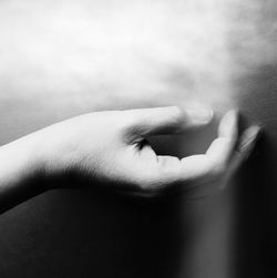 Cropped image of woman touching wall