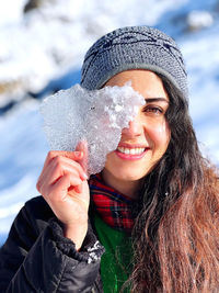 Portrait of smiling young woman standing outdoors