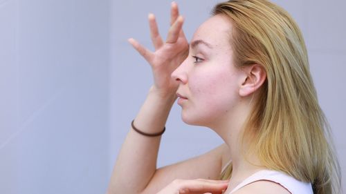 Portrait of woman against white background