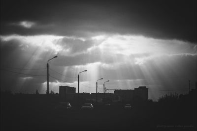 Cars on street against sky