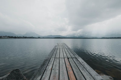 Pier over lake against sky