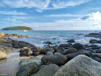 Rocks on beach against sky