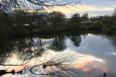 Scenic view of lake against sky at sunset