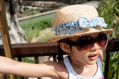 Close-up of girl wearing sunglasses hat