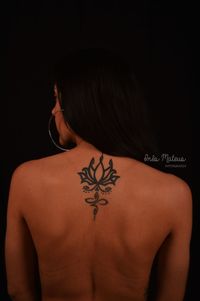 Rear view of shirtless young woman against black background