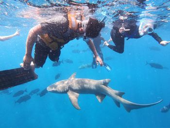 Friends scuba diving undersea