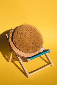 Dry massage brush on beach chair with natural bristle, ecological cosmetics, home care. bamboo brush