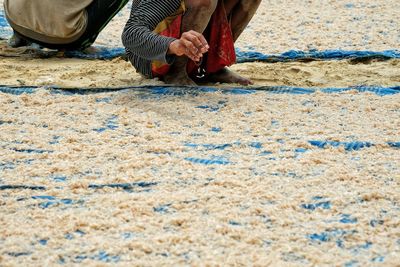 Low section of man skateboarding on sand