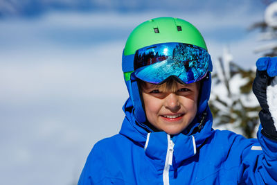 Portrait of smiling boy standing on snow