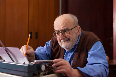 Close-up of man using typewriter