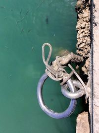 High angle view of rope tied on metal