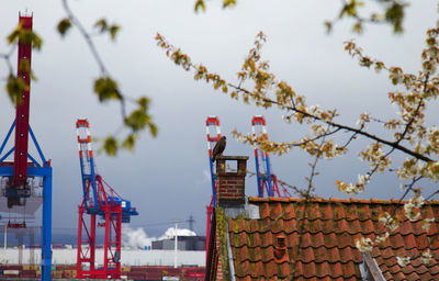 View of red bell tower against cloudy sky