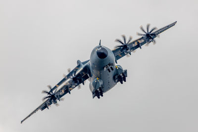 Low angle view of airplane flying against clear sky