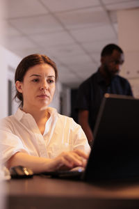 Businesswoman using laptop at office