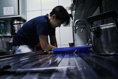 Side view of man working in commercial kitchen 