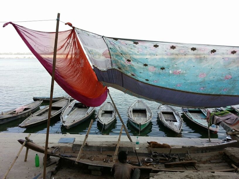 nautical vessel, boat, moored, transportation, water, mode of transport, sea, beach, sky, travel, clear sky, fishing boat, sailboat, day, rope, tranquility, shore, outdoors, horizon over water, nature