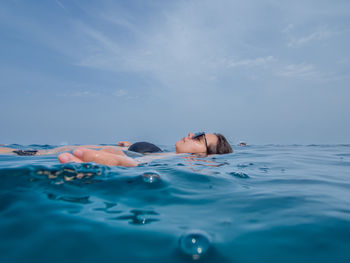Young woman swimming in sea