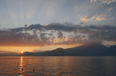 Scenic view of lago di garda  against sky during sunset