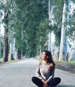 Woman sitting on road in park