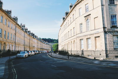Vehicles on road along buildings