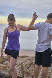 Man and woman exercising at beach