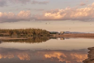 Scenic view of lake against sky during sunset